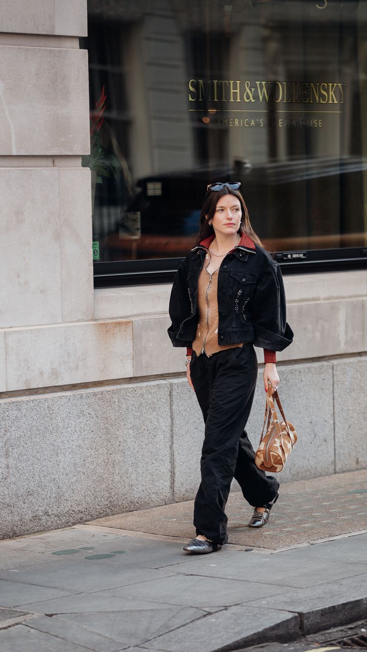 Image may contain Lydia HearstShaw Clothing Pants Pedestrian Person Accessories Bag Handbag Footwear and Shoe