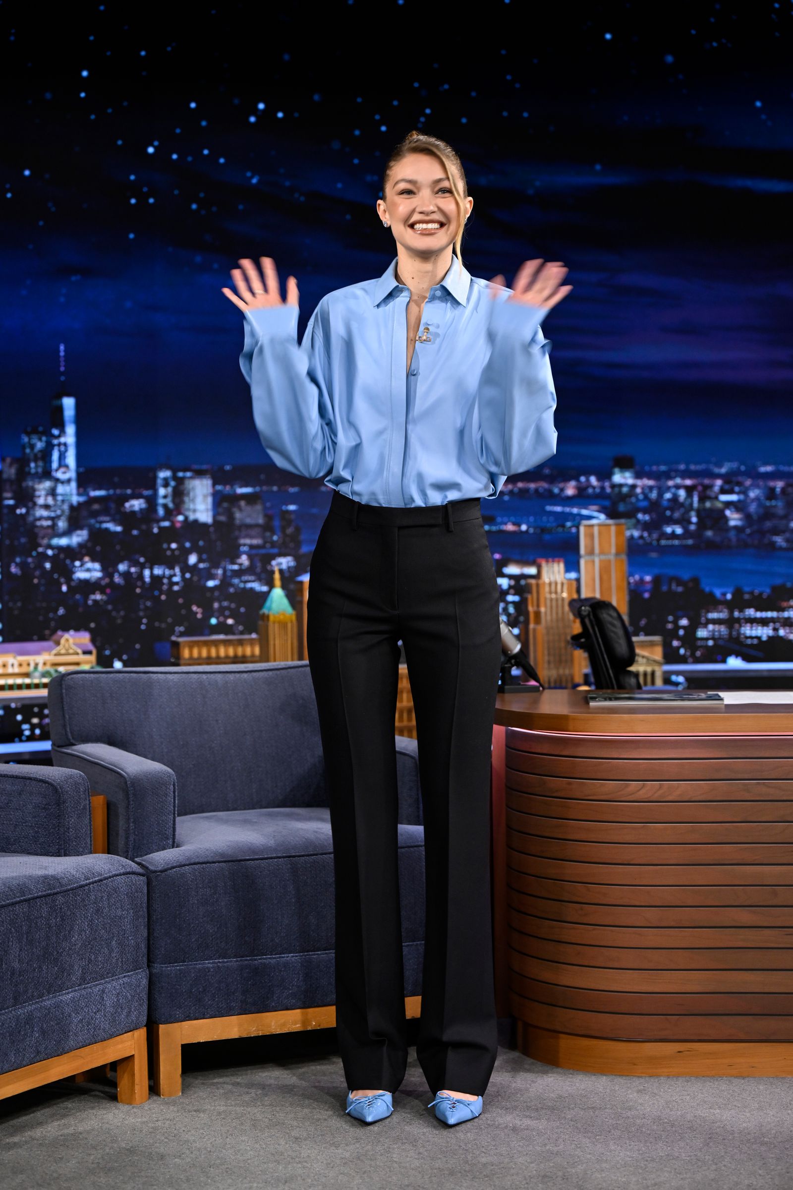 Image may contain Gigi Hadid Person Standing Adult Clothing Footwear Shoe Pants Head Face Happy and Couch