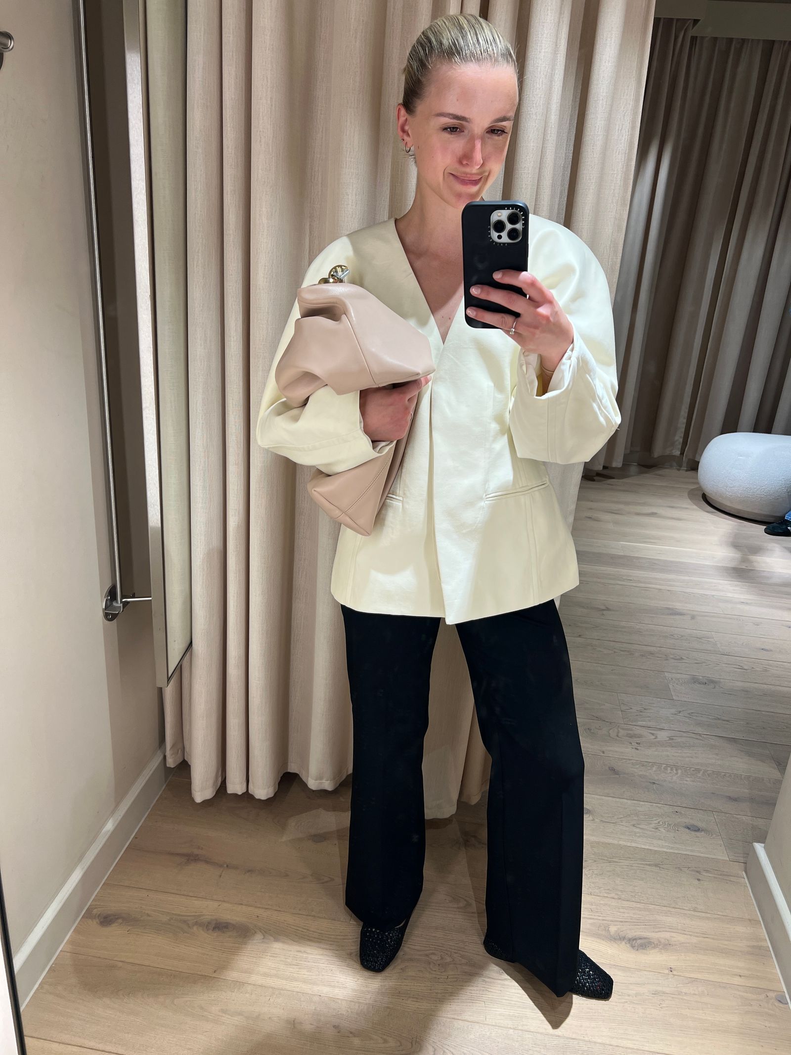 Image may contain Clothing Sleeve Pants Electronics Mobile Phone Phone Person Coat and Blouse