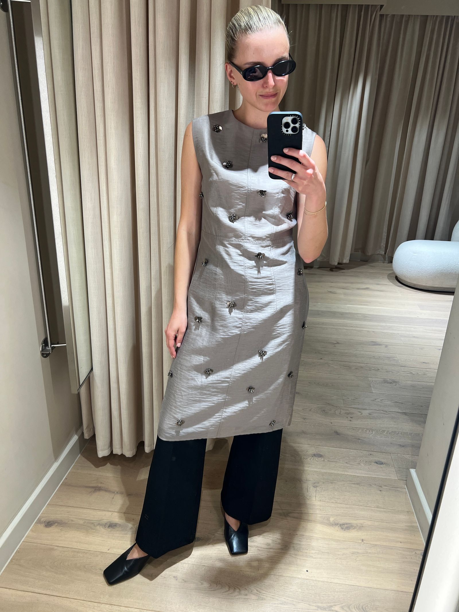 Image may contain Electronics Mobile Phone Phone Clothing Dress Adult Person Accessories Glasses and Sleeve