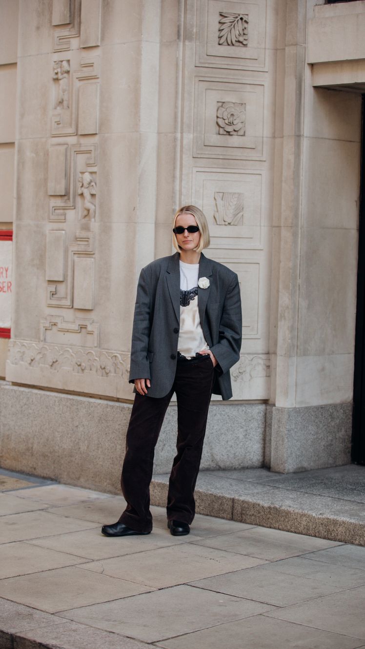 Image may contain Liz Stephen Blazer Clothing Coat Jacket Person Standing Formal Wear Suit Pants and Footwear