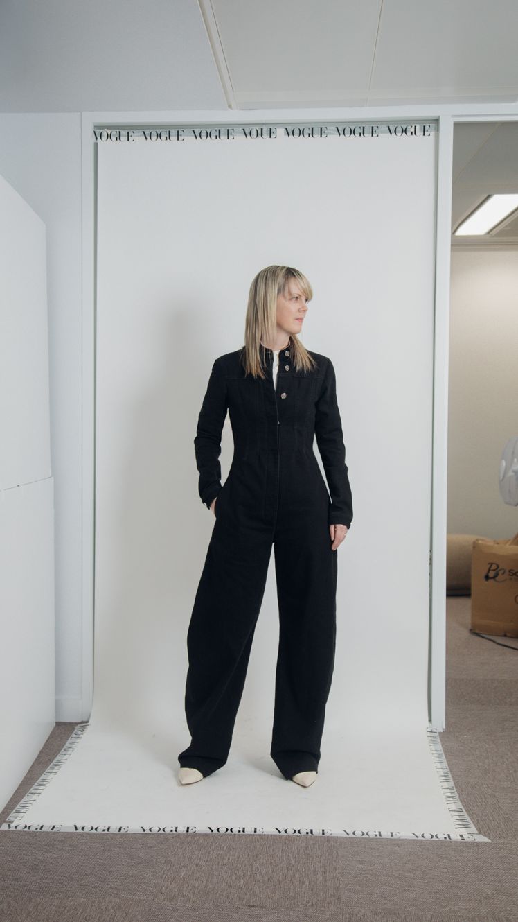 Image may contain Clothing Formal Wear Suit Pants Long Sleeve Sleeve Blazer Coat Jacket Accessories and Bag