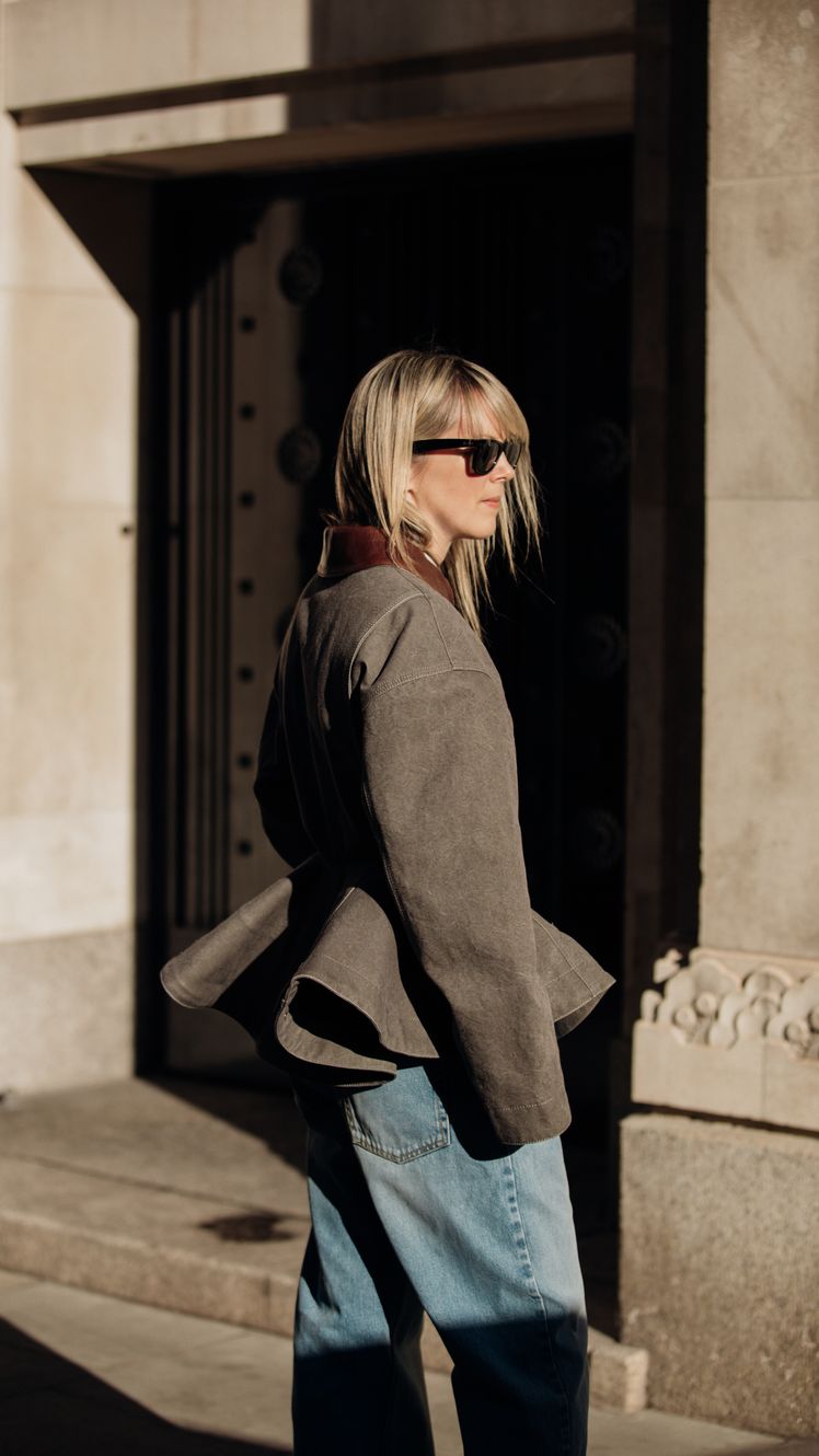 Image may contain Clothing Pants Coat Blonde Hair Person Jeans Accessories Glasses Bag Handbag and Jacket