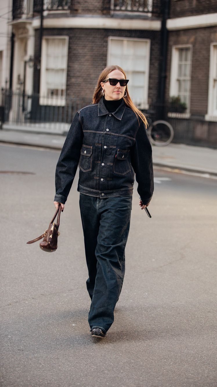 Image may contain Clothing Jeans Pants Accessories Glasses Bag Handbag Footwear Shoe Adult Person and Bicycle