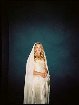 Image may contain Clothing Dress Fashion Formal Wear Gown Wedding Wedding Gown Face Head Person and Photography